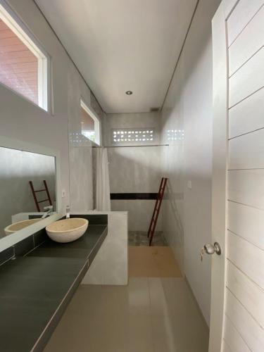 a bathroom with a sink and a mirror at Gunung Homestay Bali in Tabanan