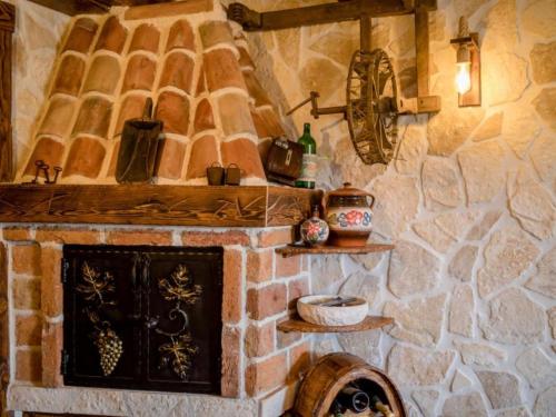 a kitchen with a stone wall with a fireplace at Apartments Scerbe Gordana & Miljenko Rab - Three Bedroom Apartment with Terrace 2 in Otok Rab