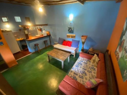 a living room with a couch and a table at Pousada do Caminho Trancoso in Porto Seguro