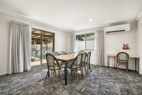 a dining room with a table and chairs at Nightcap at Kondari Resort in Hervey Bay