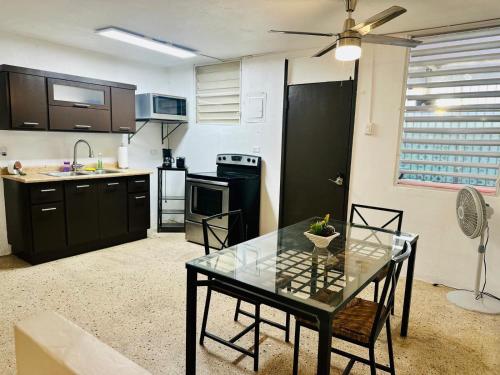 a kitchen with a glass table in a room at 3 Bedroom Home Best Price Bayamon by Rentalspr in Bayamon