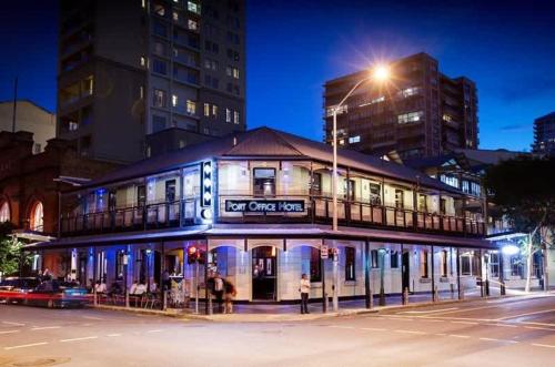 a building on the corner of a street at night at L19 Spacious Apt, Wi-Fi, Parking by Stylish Stays in Brisbane