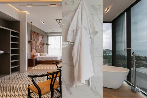 a bathroom with a tub and a bedroom at El Cielo Sayulita in Sayulita