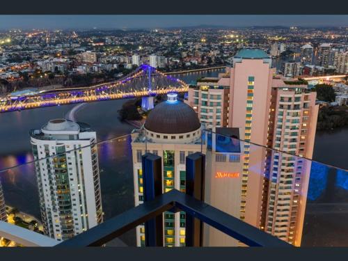 a view of a city with a bridge and buildings at LvL29 Rooftop Pool Carpark Netflix by Stylish Stays in Brisbane