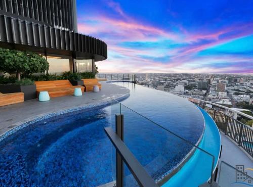 a pool on the roof of a building with a view at LvL29 Rooftop Pool Carpark Netflix by Stylish Stays in Brisbane
