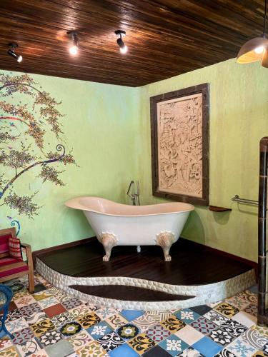 a bathroom with a large tub in a room at Bali Bohemia Huts in Ubud