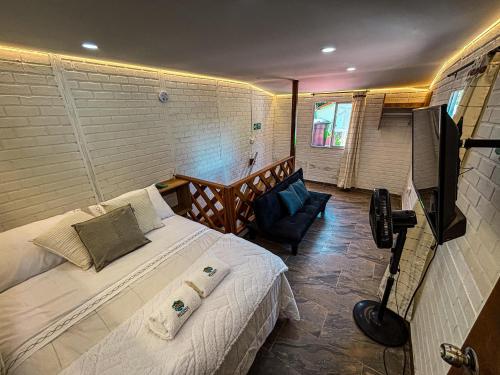 a bedroom with a bed and a chair in a room at Cabañas betania in Santa Marta
