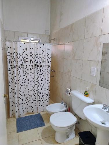 a bathroom with a toilet and a sink and a shower at Cabañas Punta Iglesia 4 in Paso de la Patria
