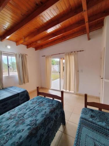 a bedroom with two beds and a large window at Cabañas Punta Iglesia 4 in Paso de la Patria