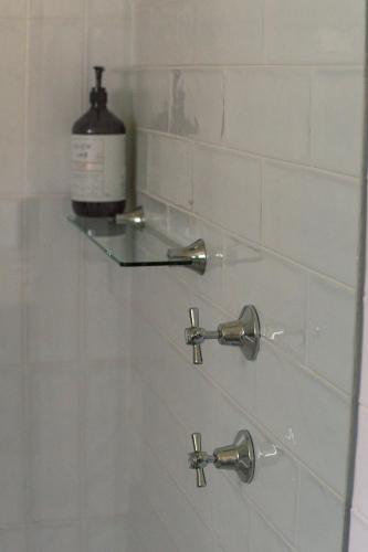 a shower with a glass shelf in a bathroom at Kooringa Cottage in Burra
