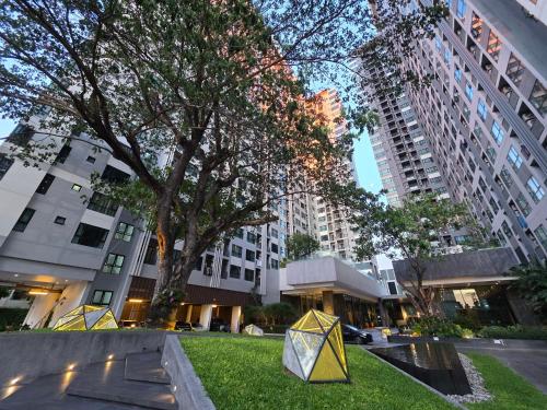 a park with kites on the grass in front of buildings at The Base Prime in Pattaya Central