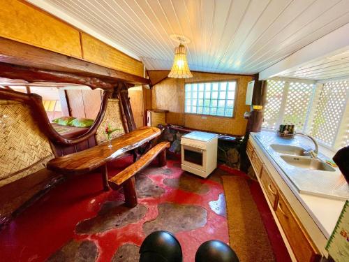 a kitchen with a sink and a bench in a room at Marū Beach House in Afareaitu