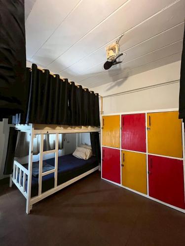two bunk beds in a room with a ceiling at Non La Mer Hostel - Bed & Yoga in Ko Lanta