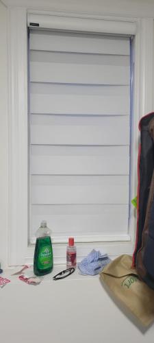 a window with a window shade and a bottle of mouthwash at Single Court in Abbotsford