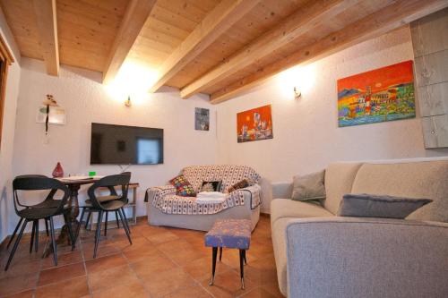 a living room with a couch and a table at In Cima alla Contrada in Pieve di Cadore