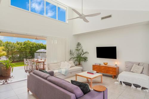 a living room with a couch and a tv at Black Rocks Hideaway - 3BR Beach Home by uHoliday in Pottsville