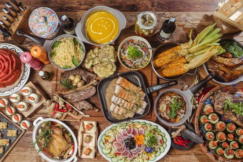 a table topped with lots of different types of food at Paradisus by Meliá Bali in Nusa Dua