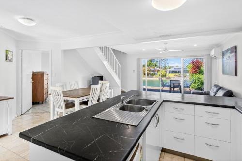 a kitchen with a sink and a counter top at Isle Of Palms Resort in Gold Coast
