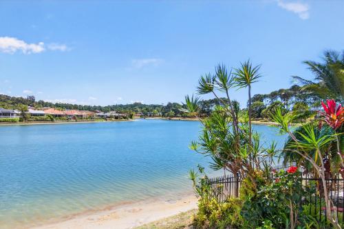 a body of water with palm trees and a beach at Isle Of Palms Resort in Gold Coast