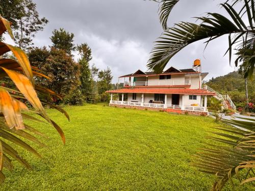 a house with a large yard in front of it at Malma view homestay in Kakkabe