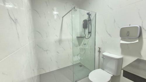 a bathroom with a shower and a toilet and a phone at The River khaosok in Khao Sok