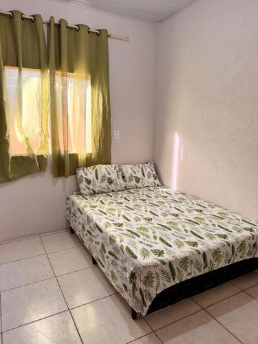 Una cama pequeña en una habitación con ventana. en Refujo Ideal em Família, en Prado