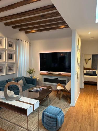 a living room with a blue couch and a tv at A Dedicated Space To Unwind in Brooklyn