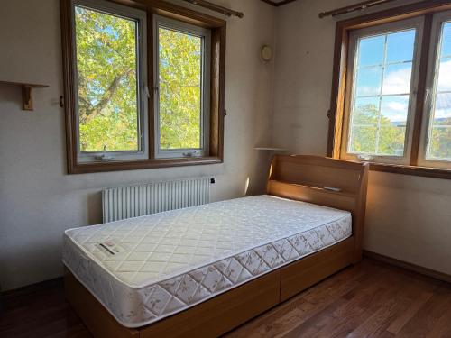 Ένα ή περισσότερα κρεβάτια σε δωμάτιο στο ペンションハートウォーマー