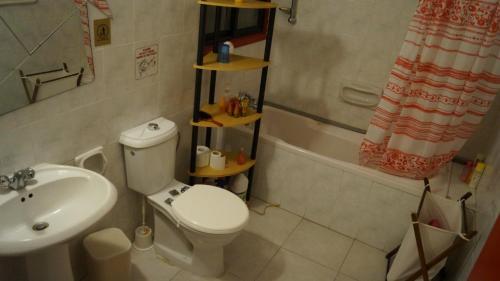 a small bathroom with a toilet and a sink at Destalo Court Larnaca Apartment in Larnaka