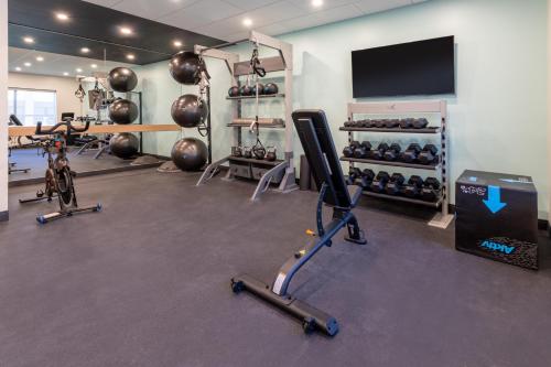 a gym with several exercise bikes and a flat screen tv at Tru By Hilton Commerce in Commerce