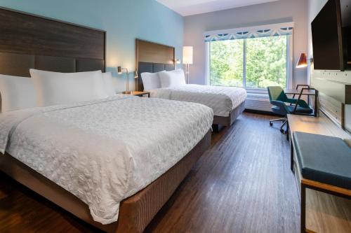 Postel nebo postele na pokoji v ubytování Tru By Hilton Commerce