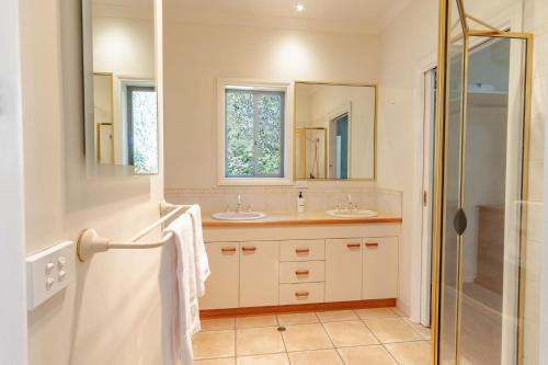 a bathroom with two sinks and a shower at Creek Haven in Bright