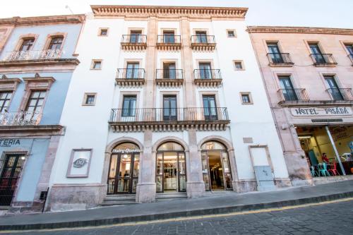 a large white building on a city street at Hotel Argento Zacatecas in Zacatecas