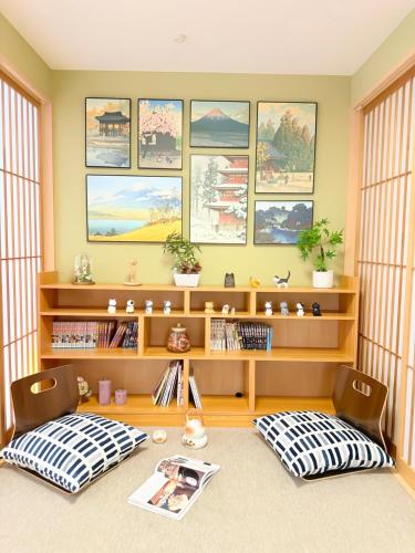 a living room with a desk and two chairs at Ōimazato-Japanese Garden Japanese Entire House with T a t ami Rooms for 8 & 5 Minutes Walk to Imazato &2 Baths 2 Toilets &Direct to Namba and Nipponbashi in Osaka