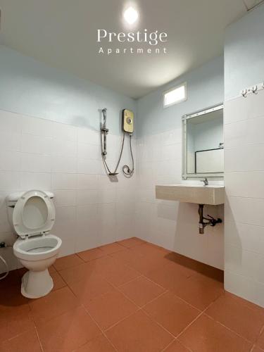 a bathroom with a toilet and a sink at Prestige in Bangna