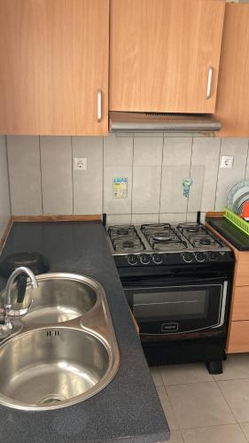 a kitchen with a sink and a stove at Prédio IFH in Vila do Maio