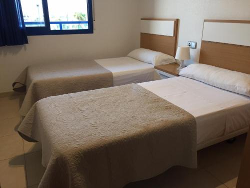 a hotel room with two beds and a window at Alicante Mar in Alicante