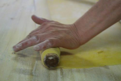 a hand reaching for a bottle on a wooden floor at Albergo Ristorante La Torricella in Poppi