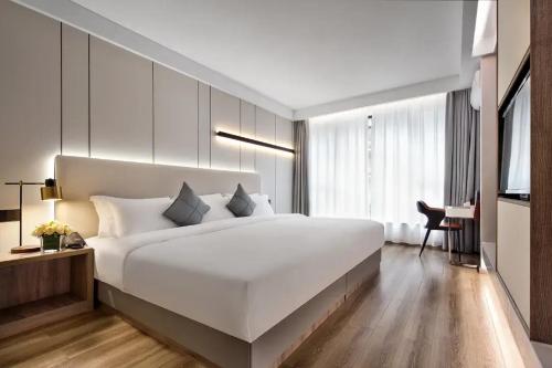 Postel nebo postele na pokoji v ubytování Miao Hotel