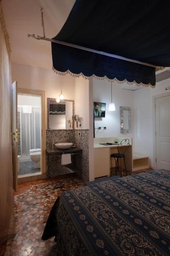 a bedroom with a large bed and a bathroom at CityHotel Cristina Vicenza in Vicenza