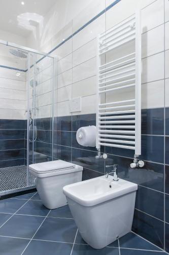 a bathroom with a toilet and a sink and a shower at Hotel America in Scafati