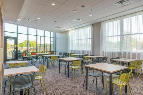 a classroom with tables and chairs and windows at Spark By Hilton Madison Central in Madison