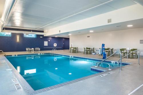 a large pool with blue water in a hotel room at Spark By Hilton Madison Central in Madison