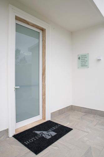 a door with a mat in front of it at Hotel America in Scafati
