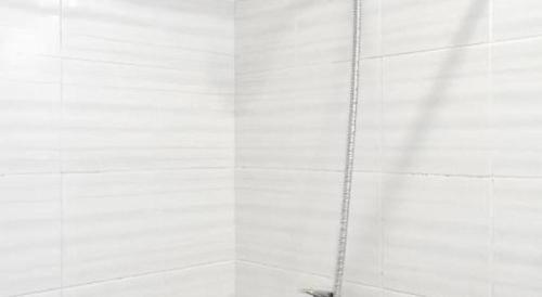 une douche avec une chaîne attachée à un mur dans l'établissement Sea Memories White Sand Beach Hotel, à Hua Hin