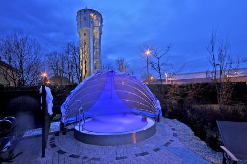 a blue umbrella sitting in front of a building at Penzion ve věži in Bohumín