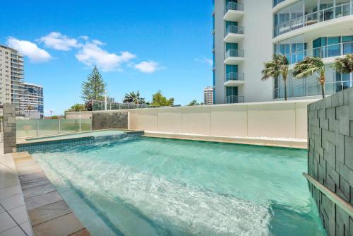 a swimming pool on the side of a building at Reflection on the Sea in Gold Coast