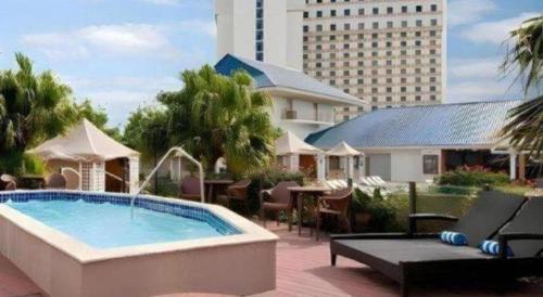 a resort pool with tables and chairs and a building at IP Casino Resort & Spa in Biloxi