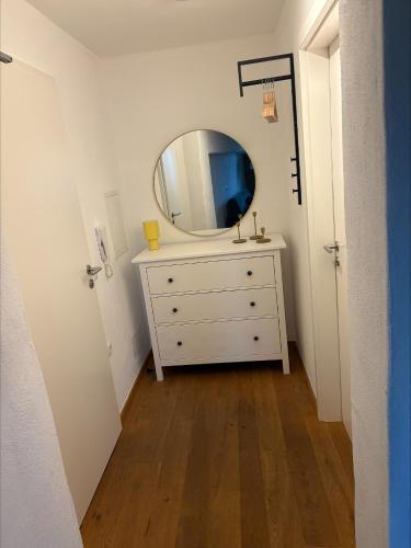 a room with a dresser with a mirror on it at Schlossblick in Sulzbach-Rosenberg