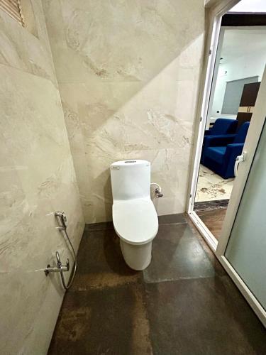 a bathroom with a toilet in a room at Sandhika Retreat in Varanasi